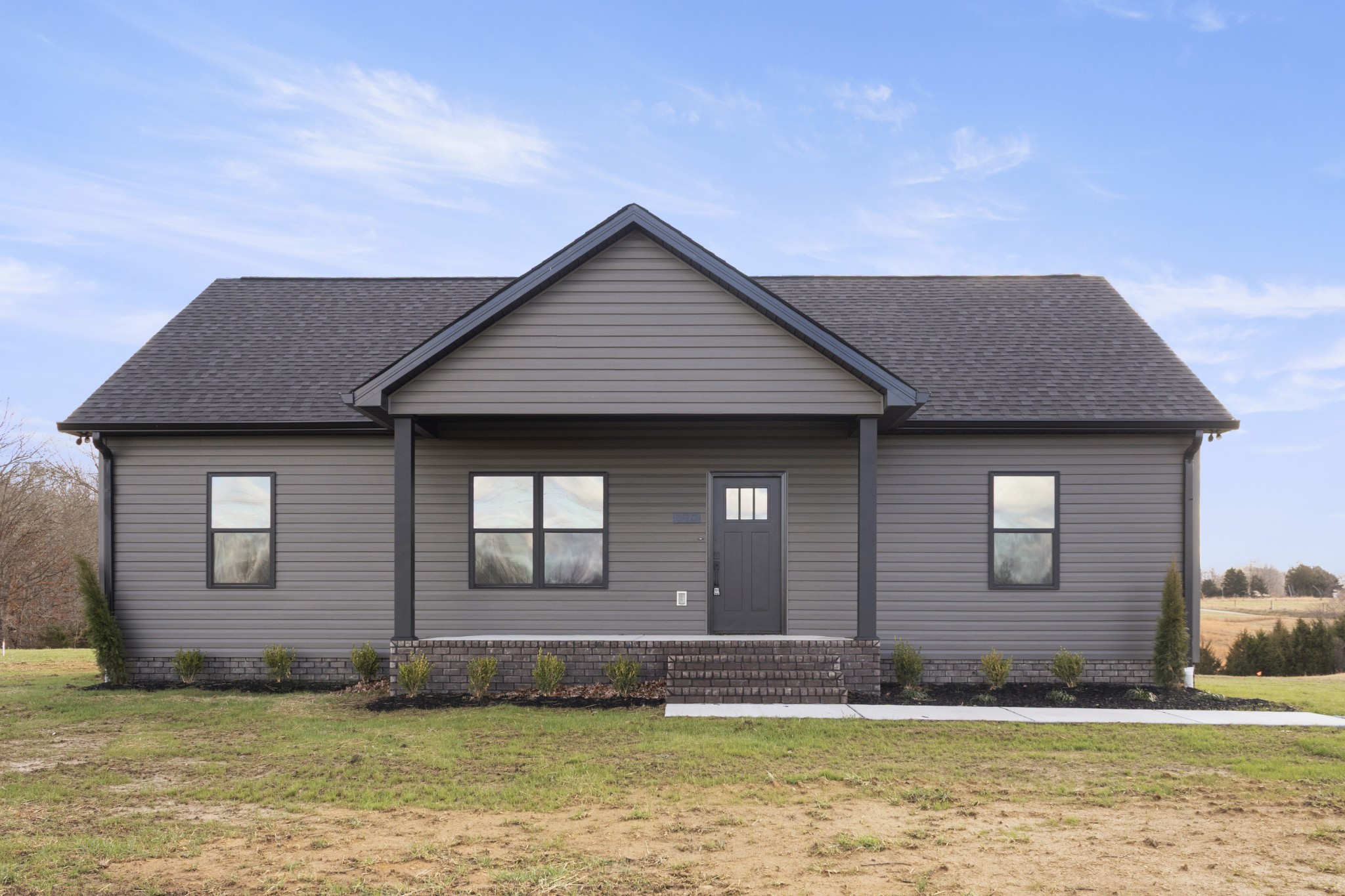 a front view of a house with a garden