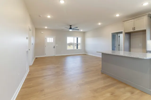 an empty room with wooden cabinet and a window