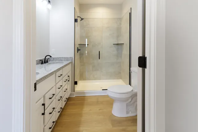 a bathroom with a sink toilet and shower