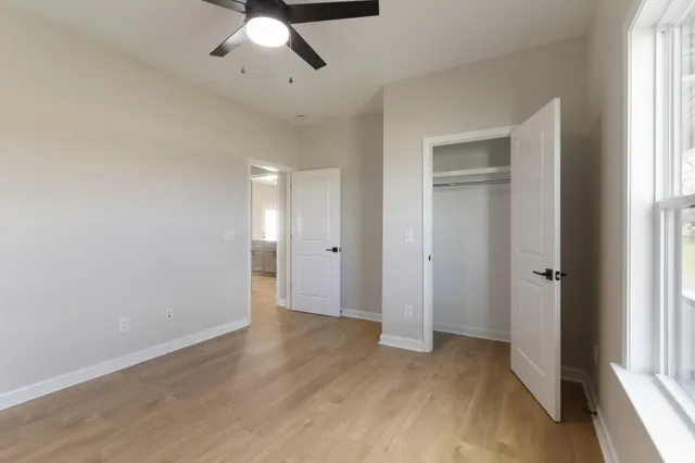 wooden floor in an empty room with a window