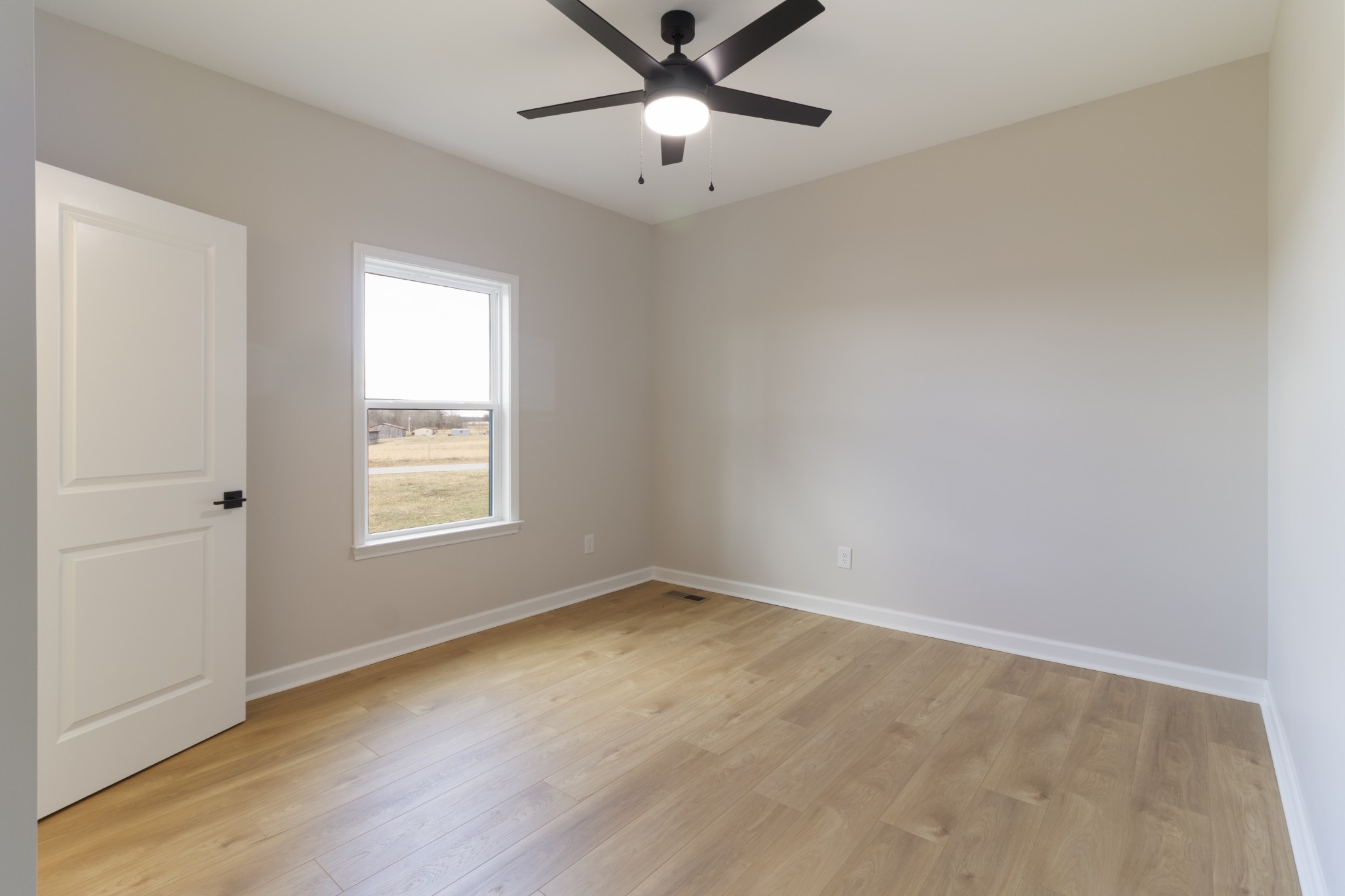 6170 Rocky Mound Road Westmoreland, TN 37186 - Photo 21 of 24 an empty room with a window and a fan