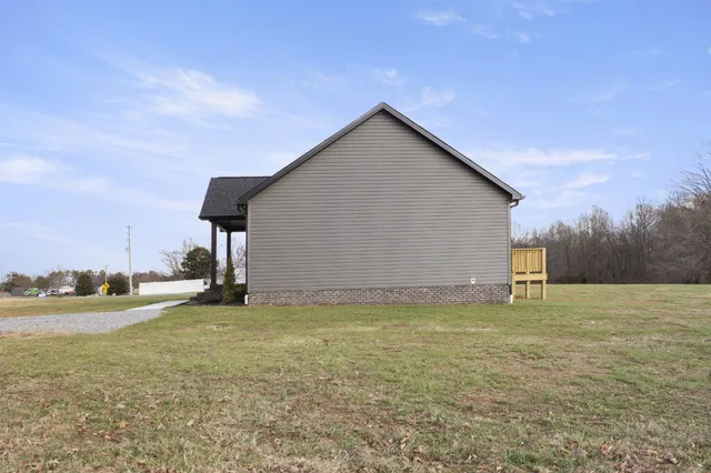a view of a house with a yard and a garage