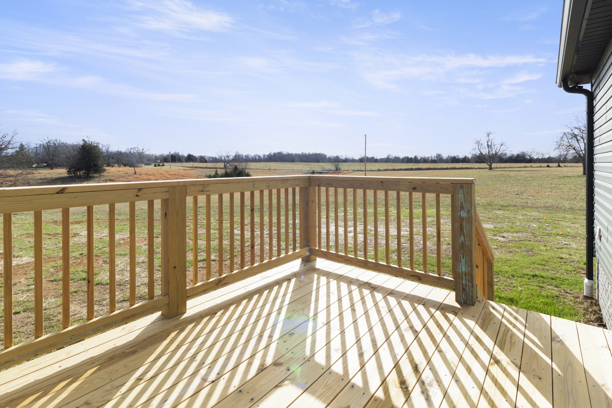 6170 Rocky Mound Road Westmoreland, TN 37186 - Photo 6 of 24 a view of a balcony with wooden floor and city view