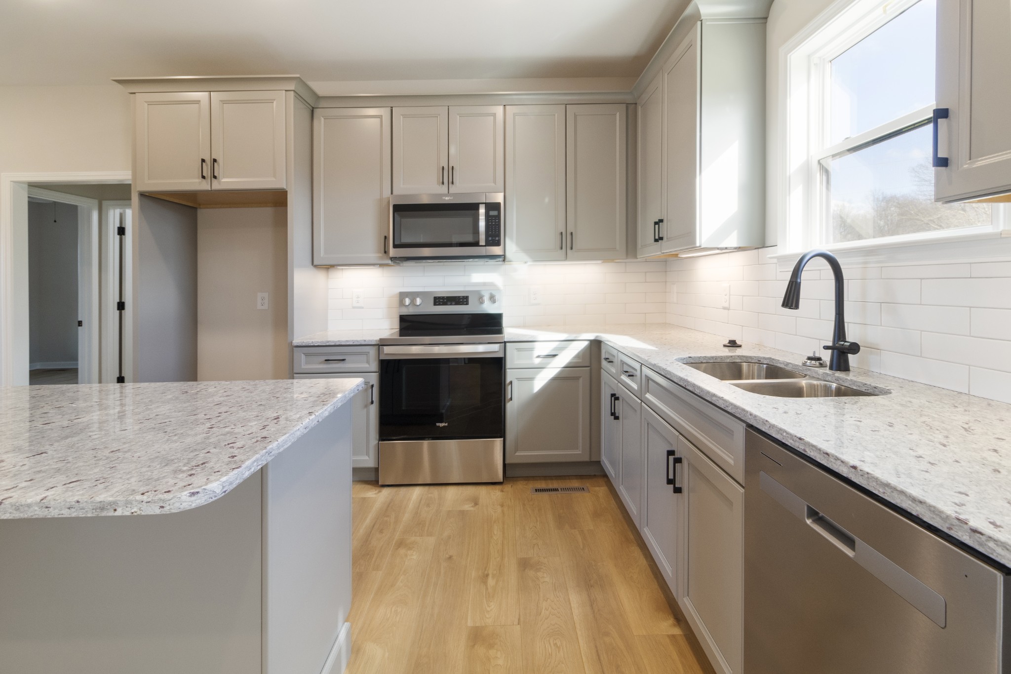 6170 Rocky Mound Road Westmoreland, TN 37186 - Photo 9 of 24 a kitchen with stainless steel appliances granite countertop a sink stove and refrigerator