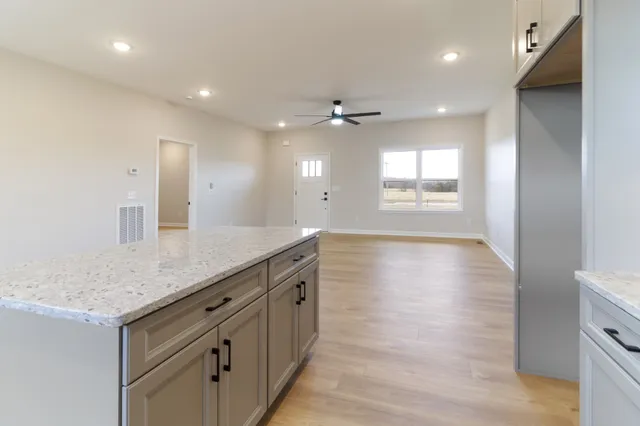 a bathroom with a granite countertop sink a large mirror and a shower
