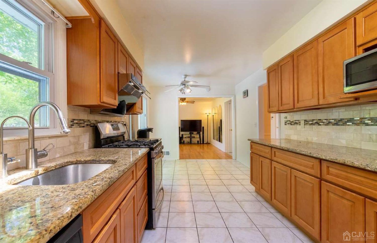 4 Devon Road Edison, NJ 08820 - Photo 18 of 35 a large kitchen with granite countertop a sink and a stove