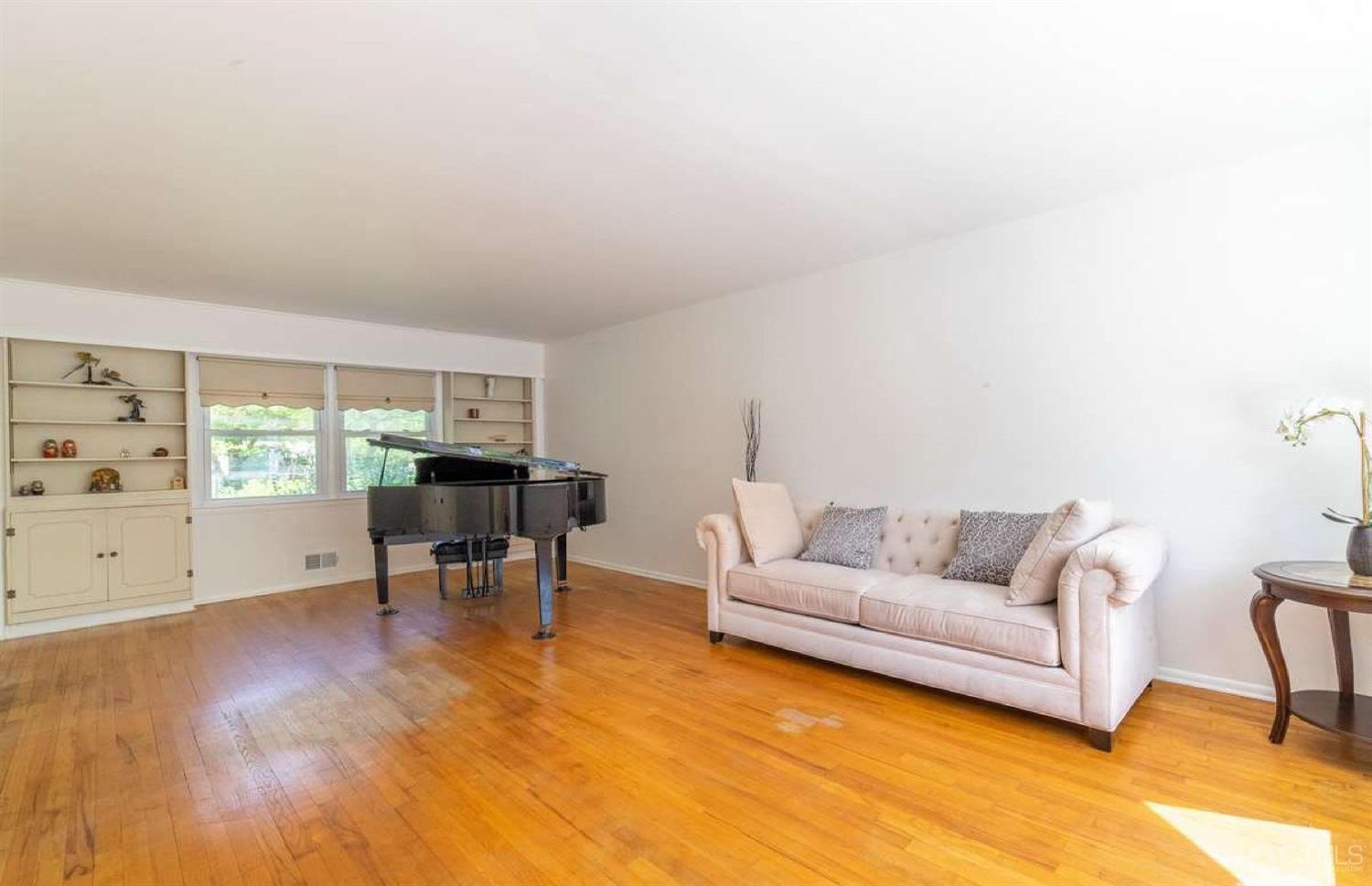 4 Devon Road Edison, NJ 08820 - Photo 9 of 35 a living room with furniture and a dining table with wooden floor