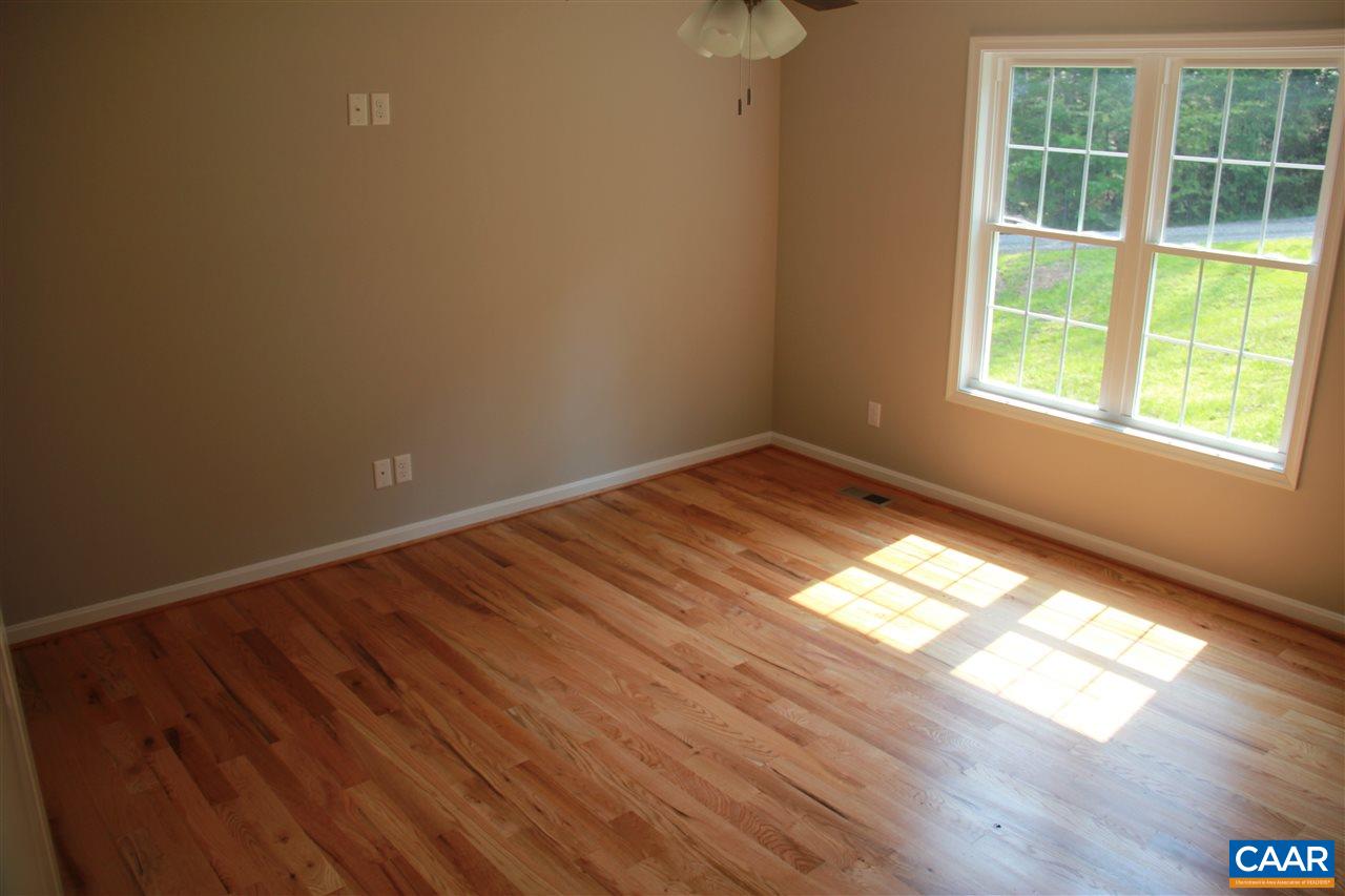 131 Farm Ridge Drive Ruckersville, VA 22968 - Photo 8 of 32 a view of empty room with wooden floor and fan