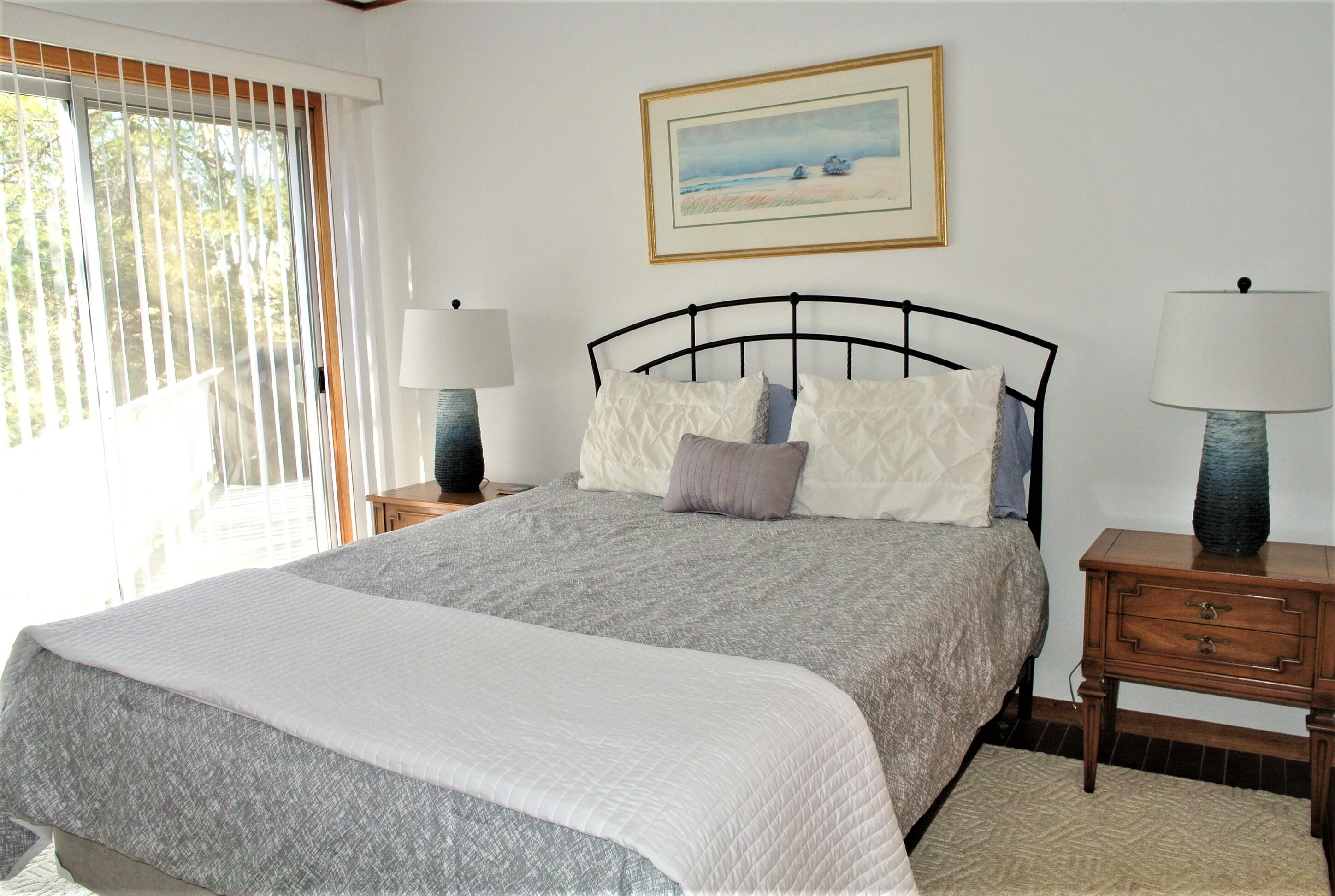 163 Greensward Road Mashpee, MA 02649 - Photo 15 of 37 a bedroom with a bed and a painting on the wall