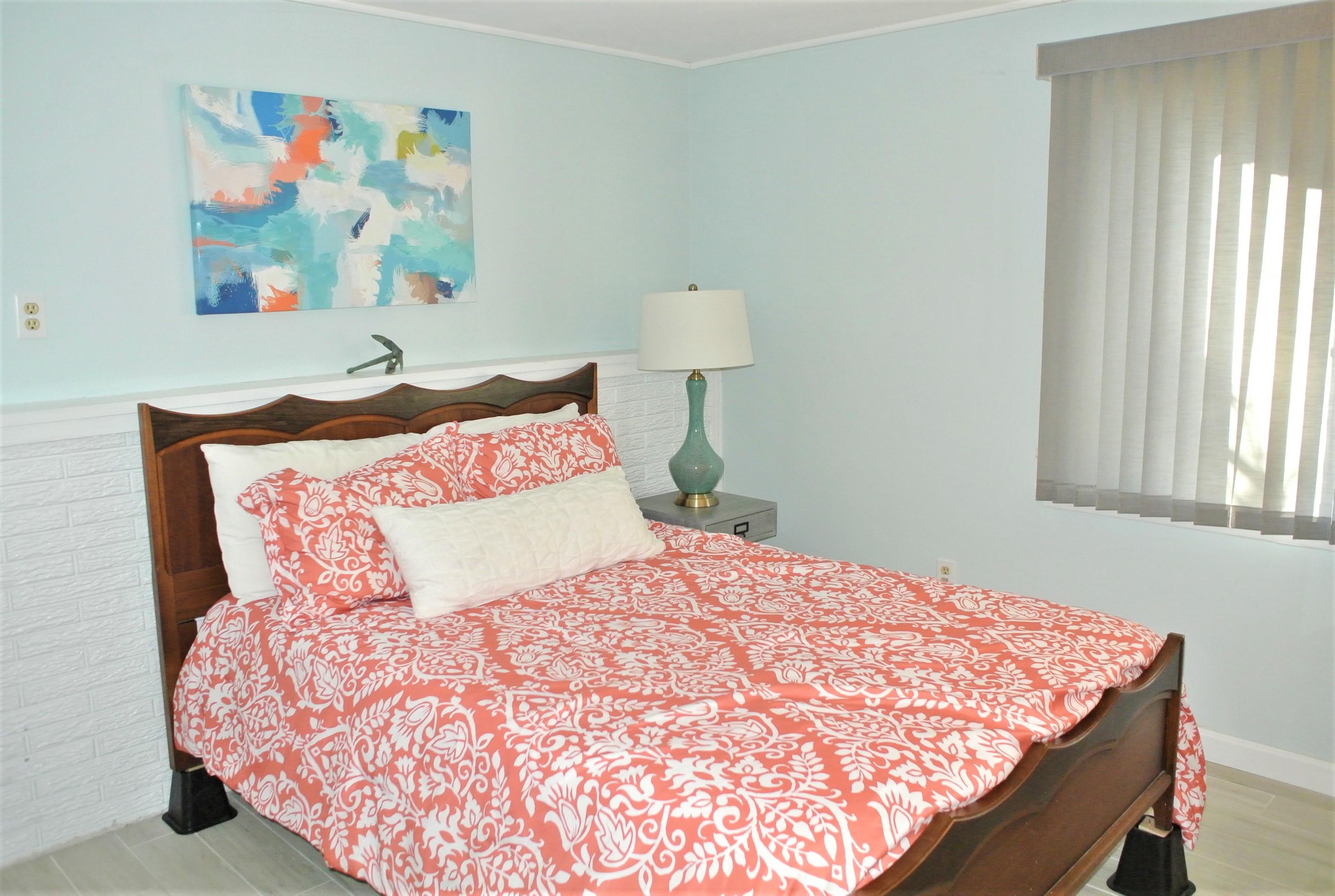 163 Greensward Road Mashpee, MA 02649 - Photo 18 of 37 a bedroom with a bed and painting on the wall