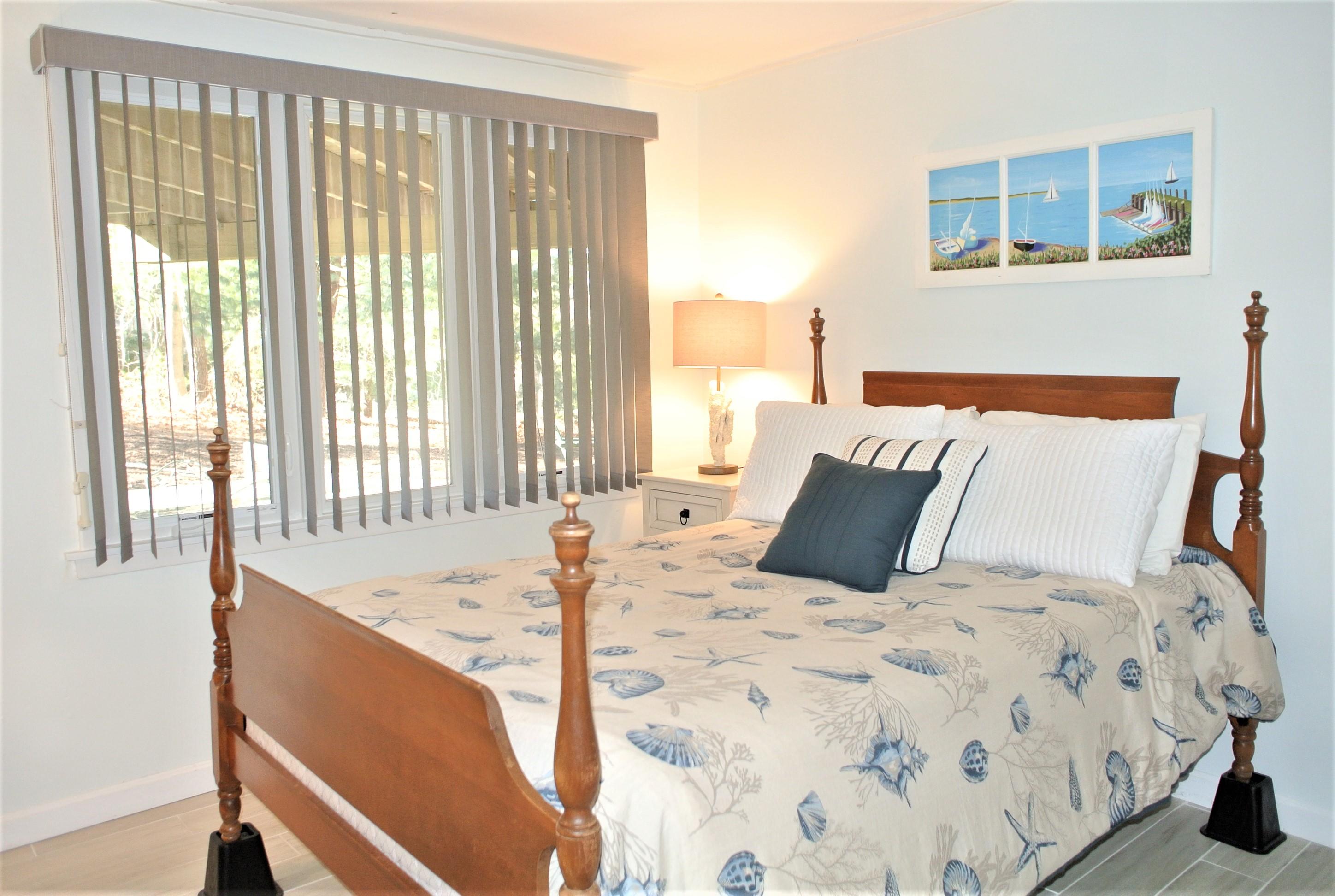 163 Greensward Road Mashpee, MA 02649 - Photo 19 of 37 a bed sitting in a bedroom next to a window