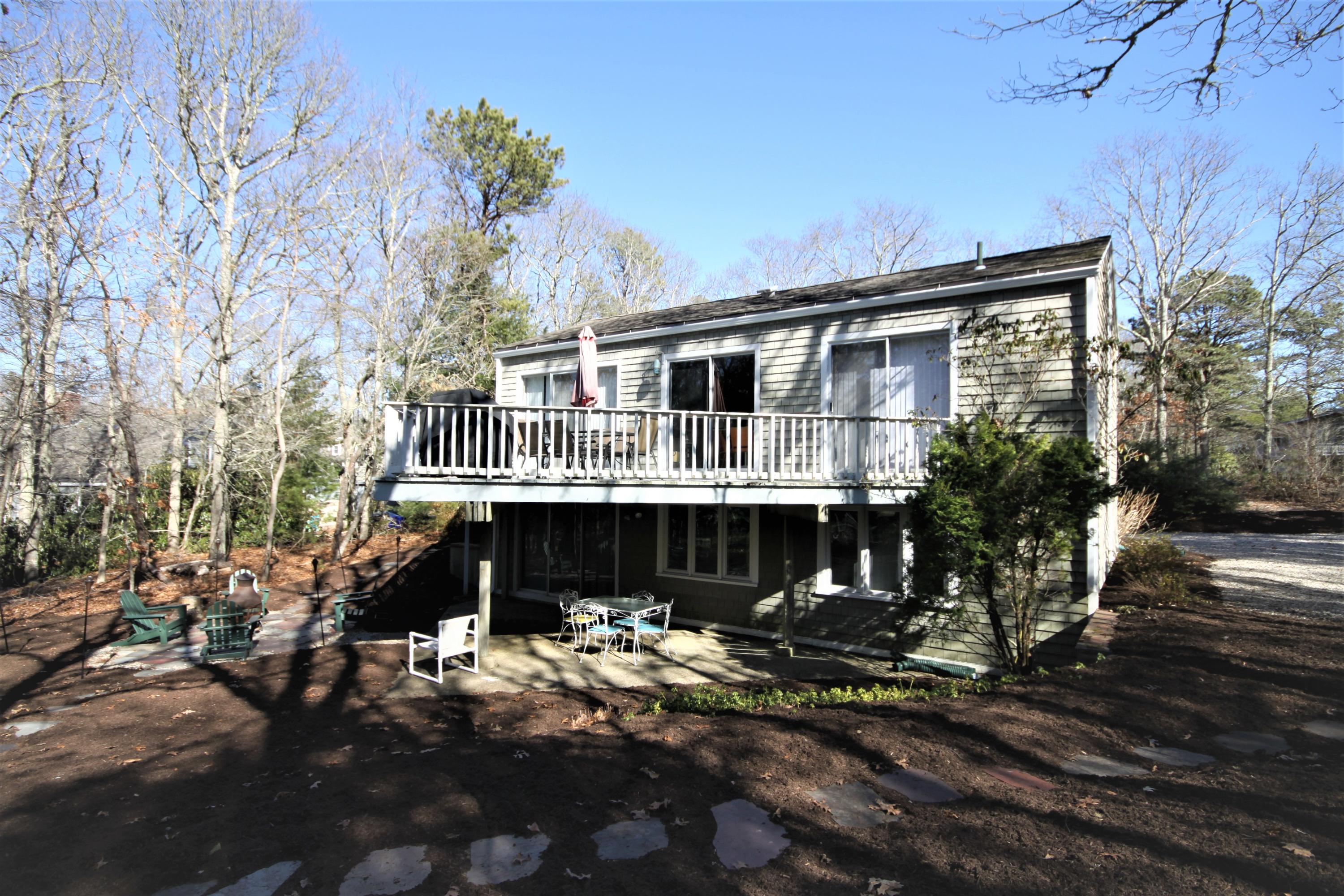 163 Greensward Road Mashpee, MA 02649 - Photo 2 of 37 a front view of a house with a yard