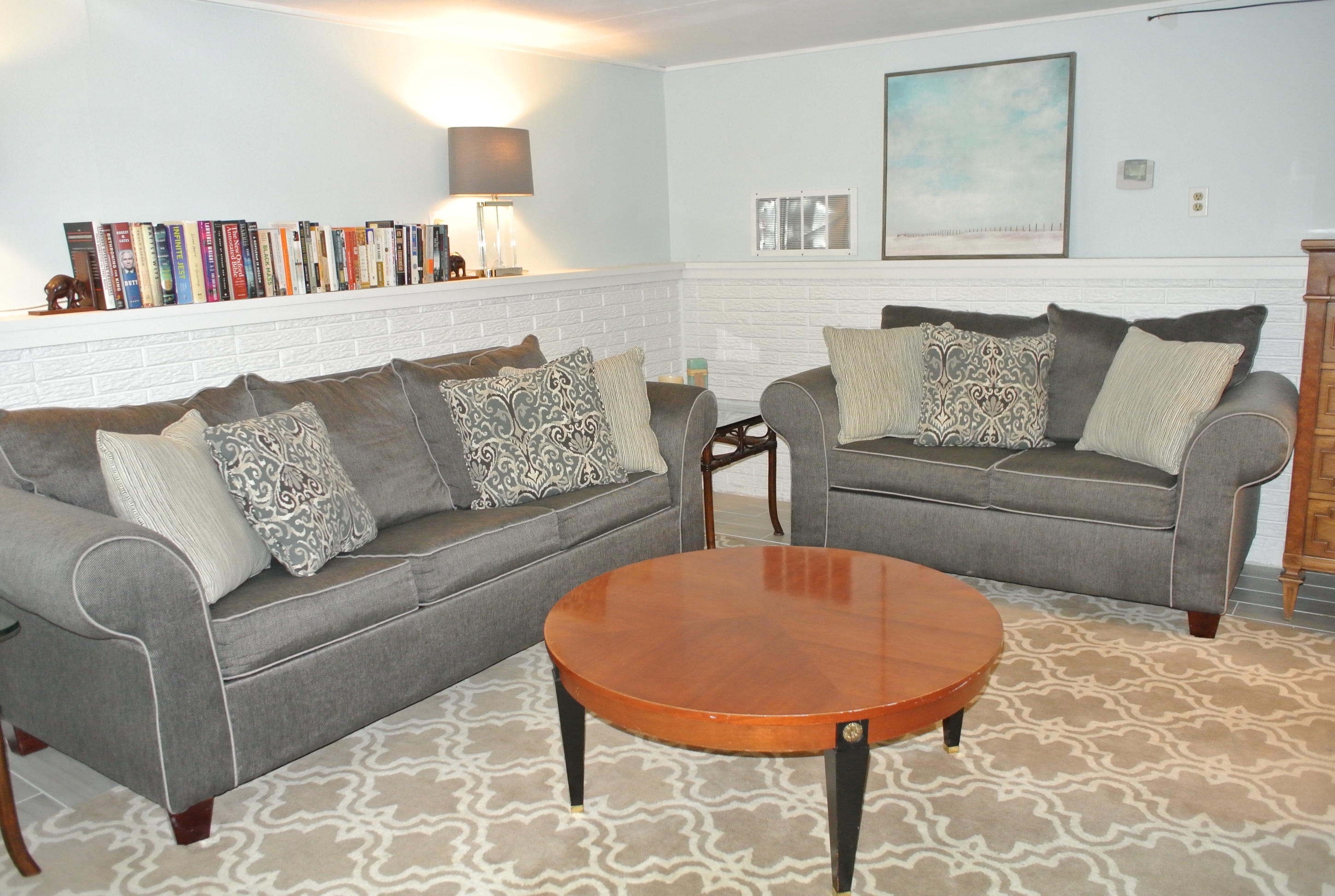 163 Greensward Road Mashpee, MA 02649 - Photo 23 of 37 a living room with furniture and a book shelf