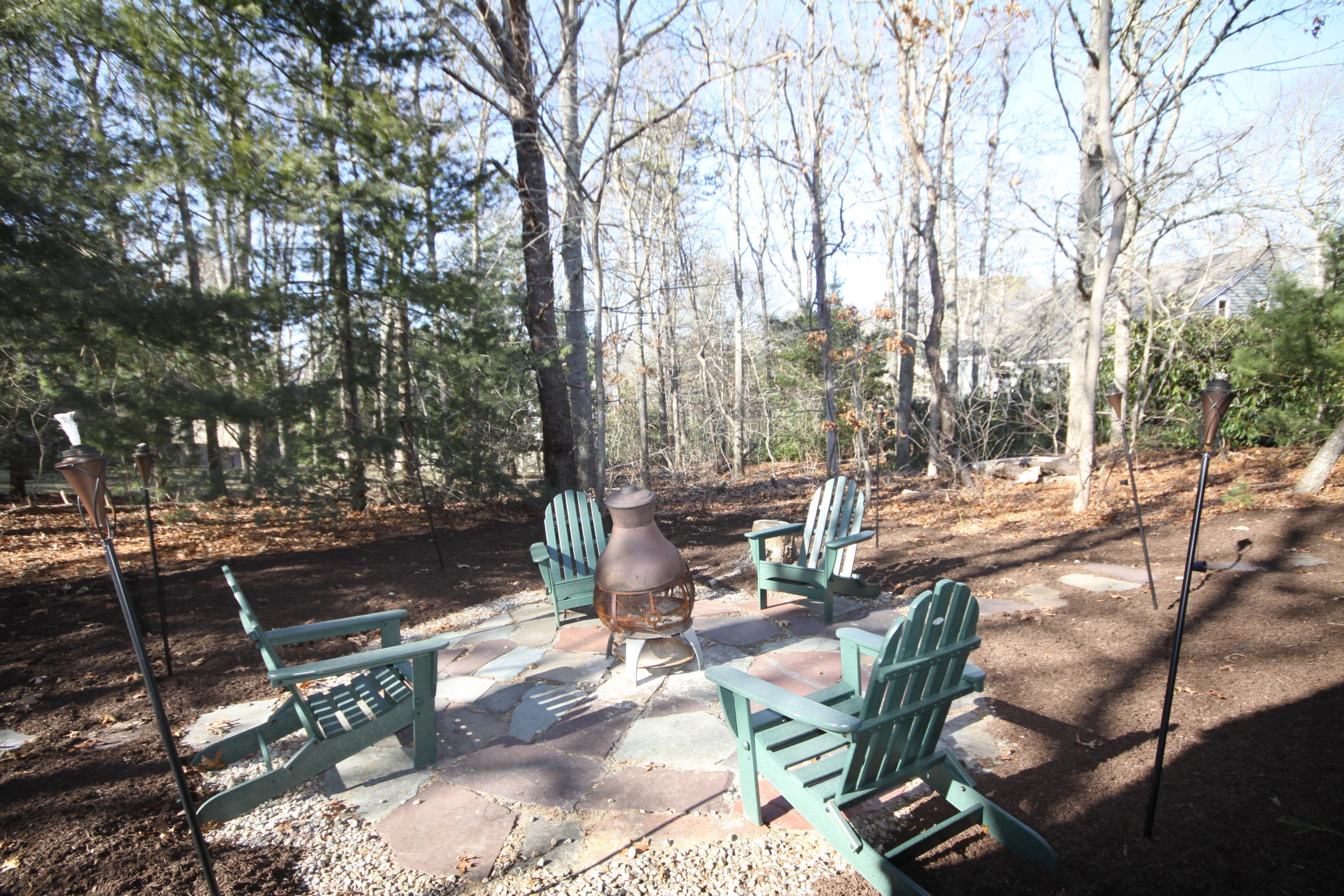 163 Greensward Road Mashpee, MA 02649 - Photo 28 of 37 a view of backyard with table and chairs and a barbeque with potted plants