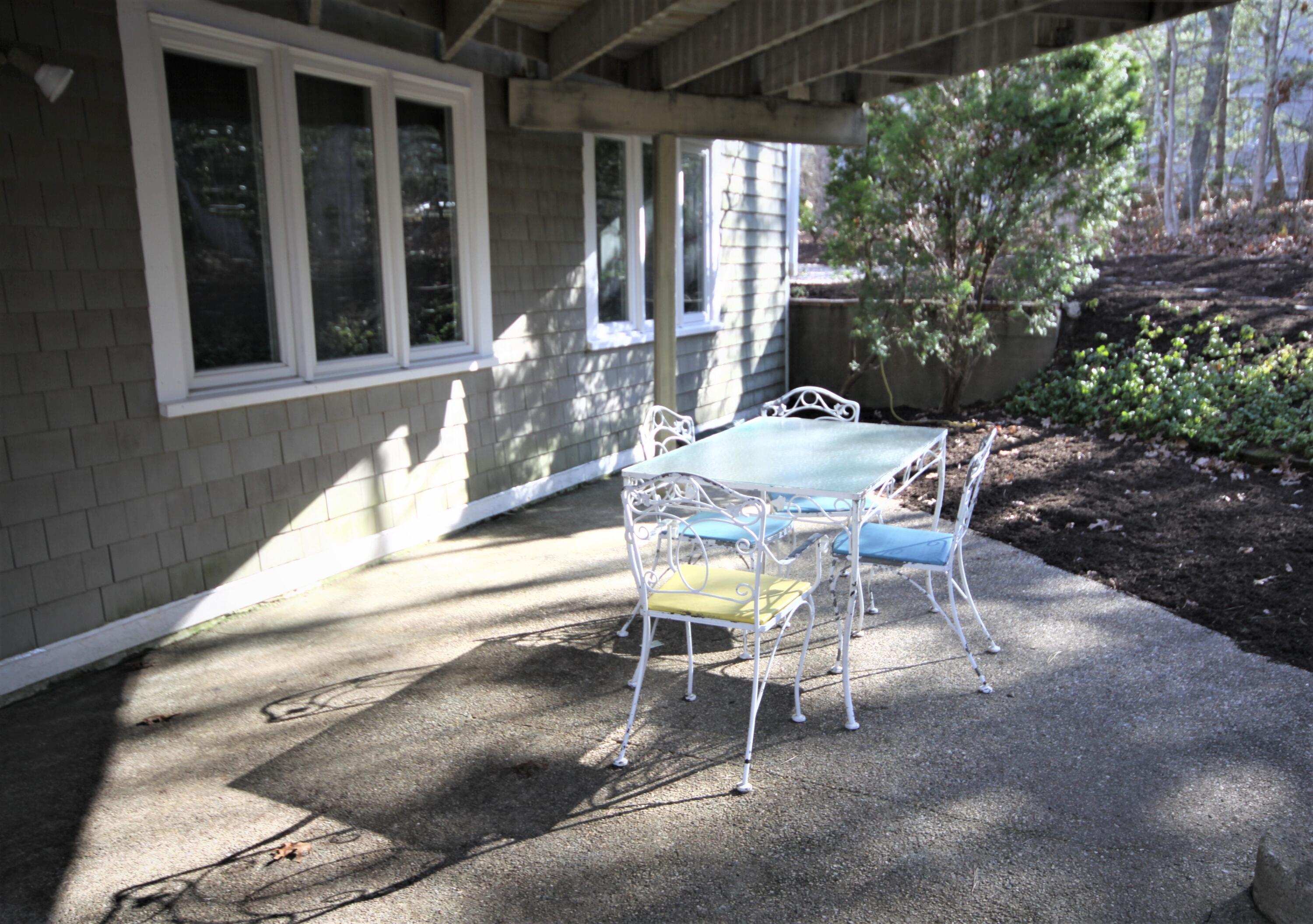 163 Greensward Road Mashpee, MA 02649 - Photo 30 of 37 a view of a patio with table and chairs and potted plants