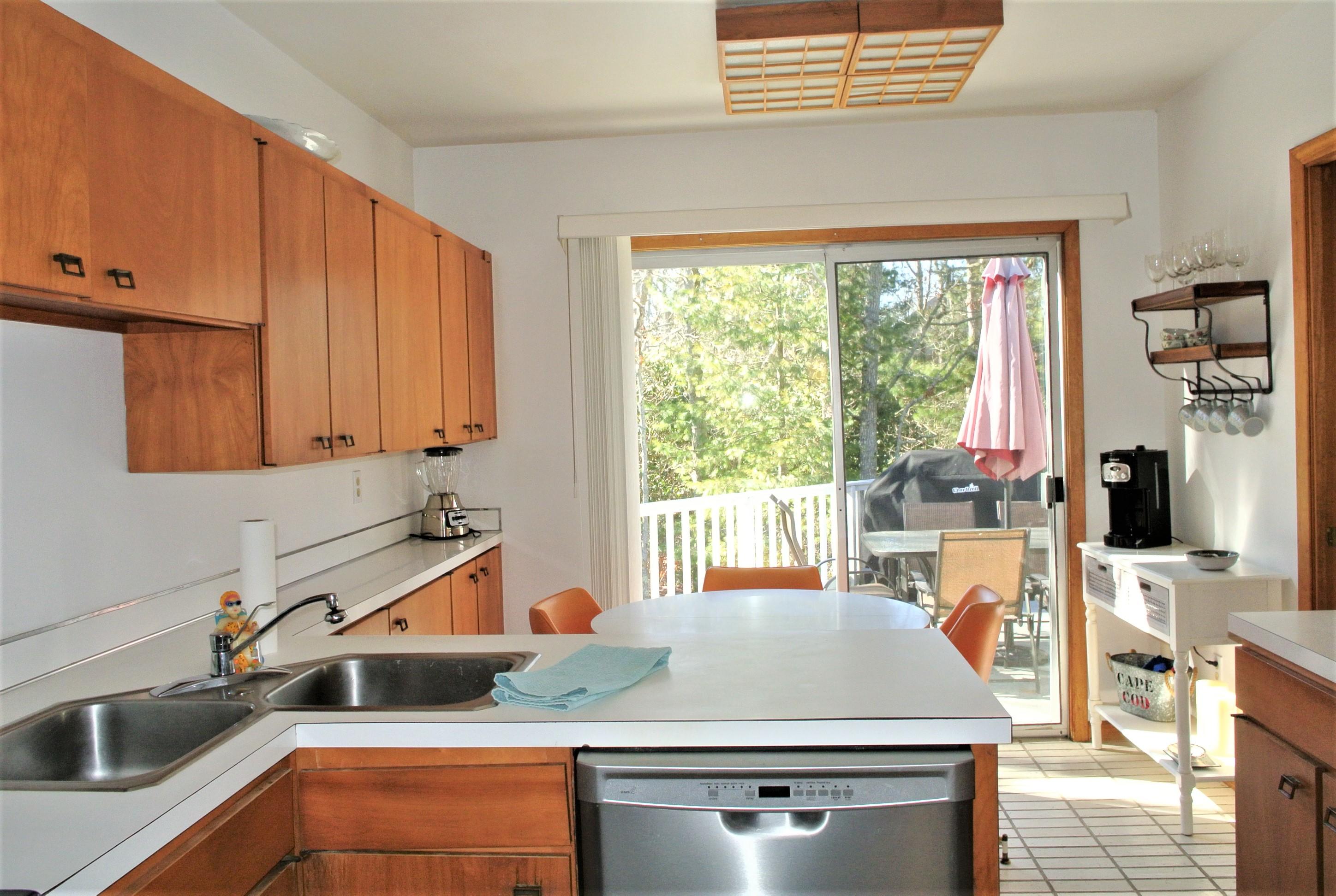 163 Greensward Road Mashpee, MA 02649 - Photo 4 of 37 a kitchen with stainless steel appliances granite countertop a stove a sink and a microwave