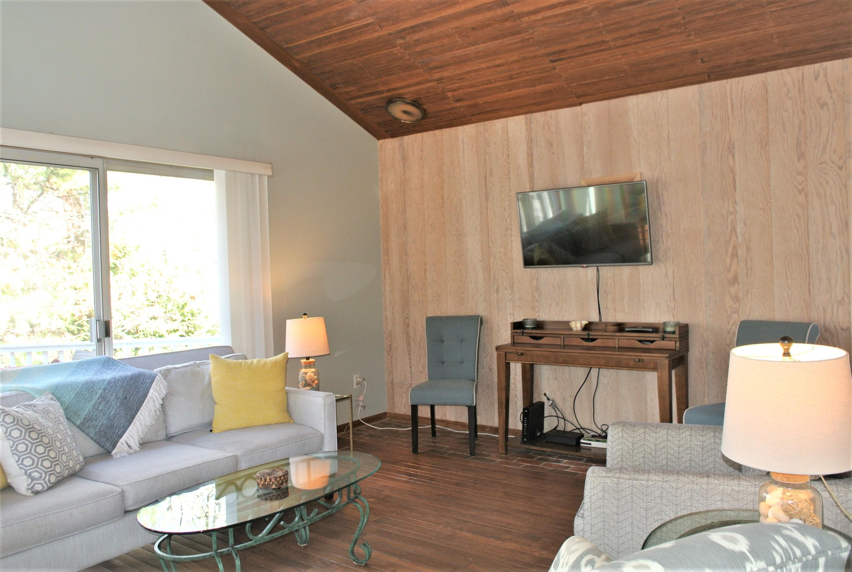 163 Greensward Road Mashpee, MA 02649 - Photo 8 of 37 a living room with furniture a flat screen tv and a large window