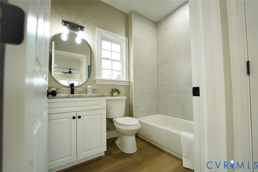 2328 Pocoshock Boulevard North Chesterfield, VA 23235 - Photo 13 of 29 a bathroom with a sink a toilet and shower