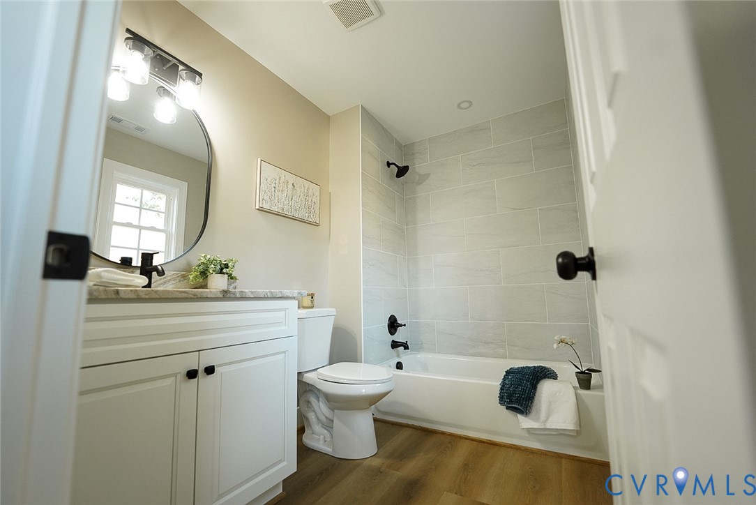2328 Pocoshock Boulevard North Chesterfield, VA 23235 - Photo 16 of 29 a bathroom with a sink a toilet and a mirror