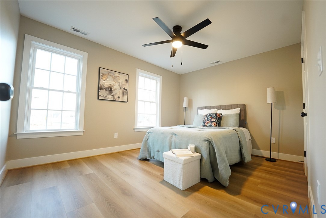 2328 Pocoshock Boulevard North Chesterfield, VA 23235 - Photo 19 of 29 a bedroom with a bed and wooden floor