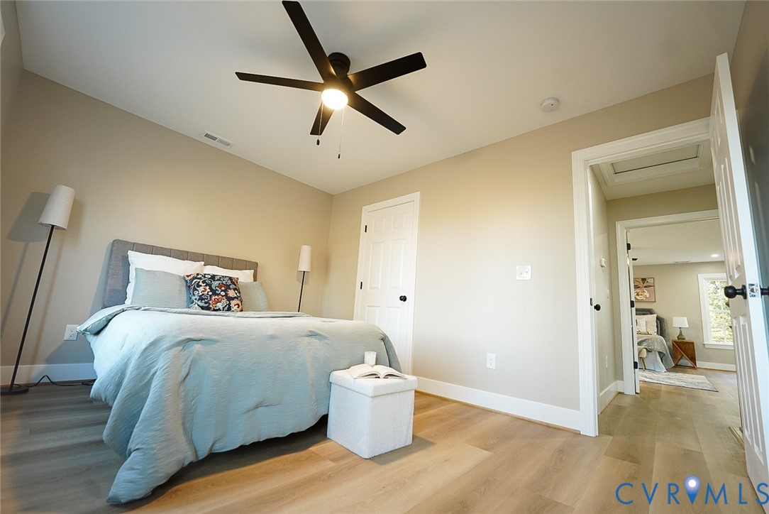 2328 Pocoshock Boulevard North Chesterfield, VA 23235 - Photo 20 of 29 a bedroom with a bed and a painting on the wall