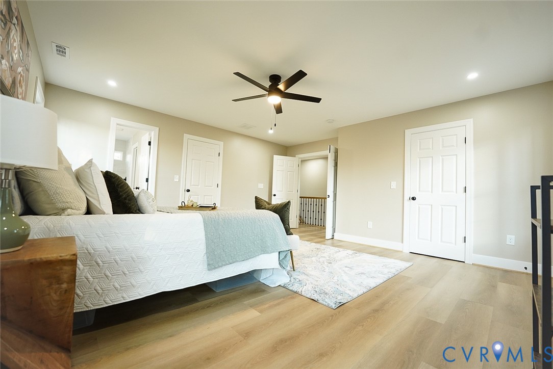2328 Pocoshock Boulevard North Chesterfield, VA 23235 - Photo 22 of 29 a spacious bedroom with a bed and a chandelier