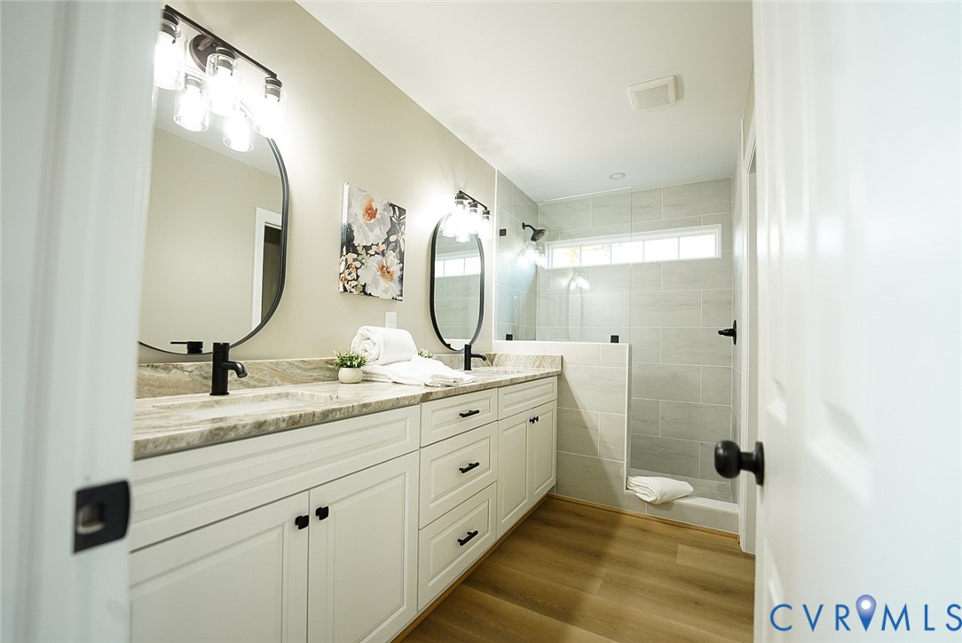 2328 Pocoshock Boulevard North Chesterfield, VA 23235 - Photo 25 of 29 a bathroom with a double vanity sink and mirror with shower