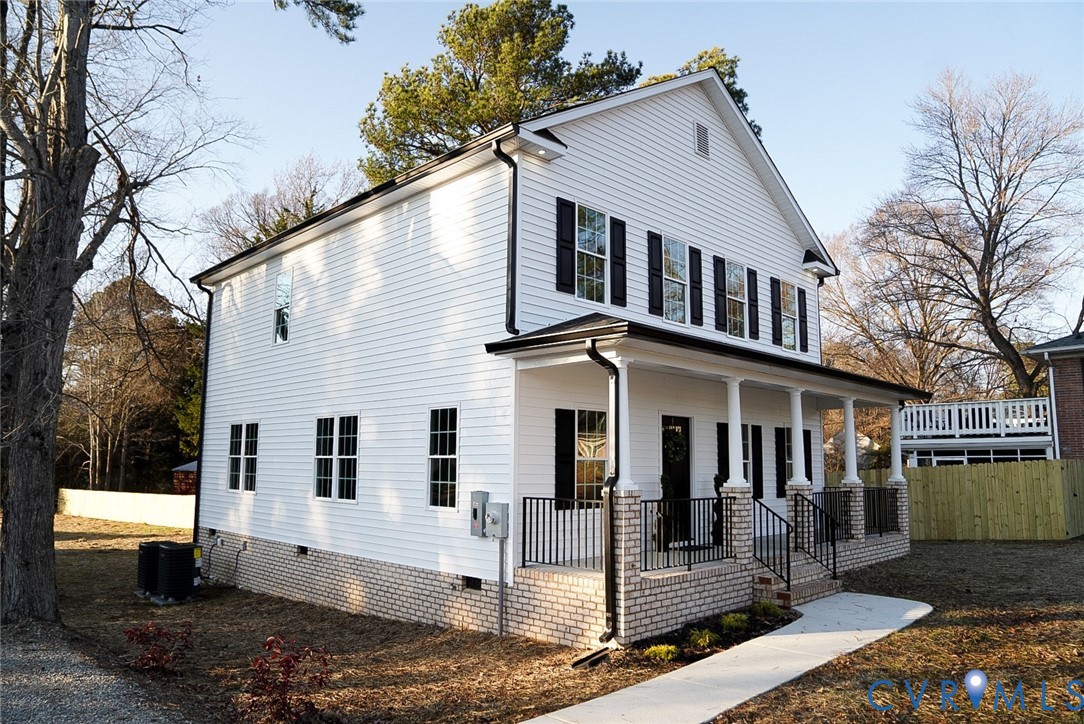 2328 Pocoshock Boulevard North Chesterfield, VA 23235 - Photo 3 of 29 a view of a white house with large windows next to a road
