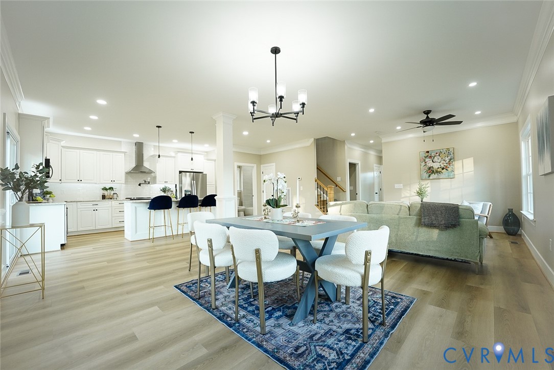 2328 Pocoshock Boulevard North Chesterfield, VA 23235 - Photo 5 of 29 a view of a dining room and livingroom with furniture wooden floor a rug and a chandelier