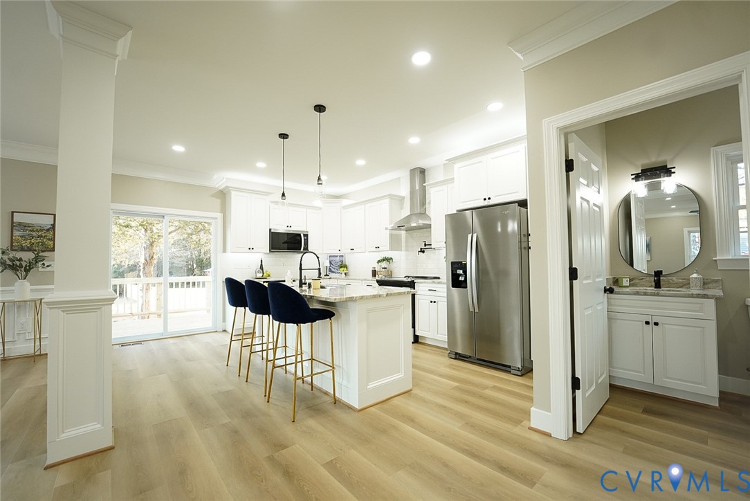 2328 Pocoshock Boulevard North Chesterfield, VA 23235 - Photo 6 of 29 a kitchen with kitchen island white cabinets and stainless steel appliances