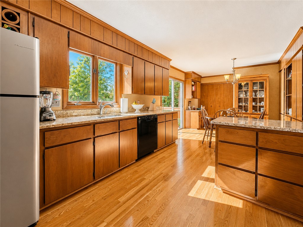 222 Terrace Drive Anderson, SC 29621 - Photo 3 of 37 A well-lit kitchen with natural wood cabinetry and gleaming hardwood floors awaits culinary adventures.
