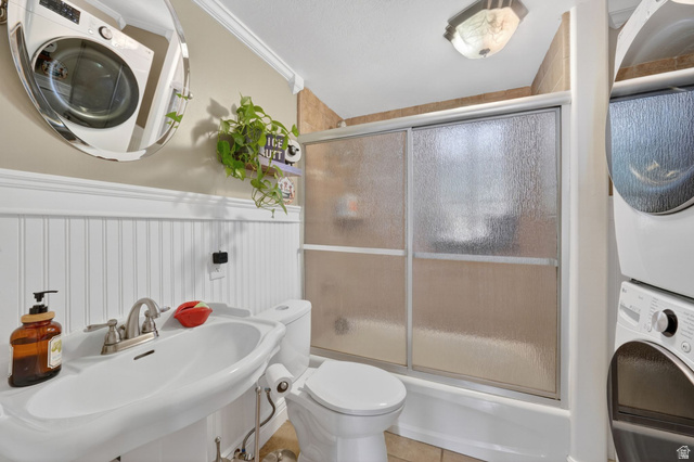 415 East 400 North Santaquin, UT 84655 - Photo 24 of 39 Bathroom featuring a pedestal sink with a brushed nickel faucet, a toilet, and a combination tub/shower with sliding frosted glass doors