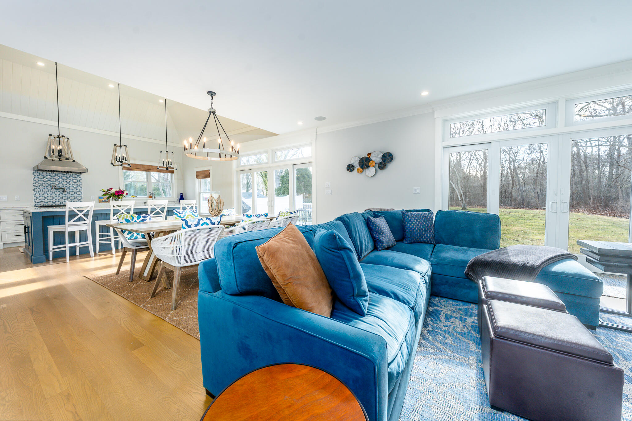 67 Fire Station Road Osterville, MA 02655 - Photo 20 of 53 a living room with furniture a large window and a chandelier