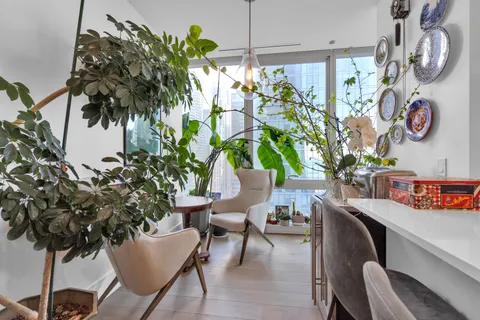 a view of a dining room with furniture window and wooden floor