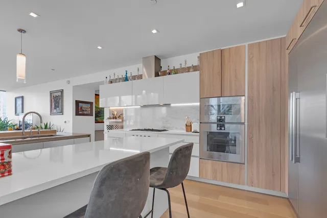 a view of a backyard with plants and lake view