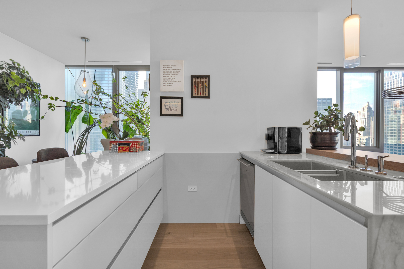 363 East Wacker Drive, Unit 1402 Chicago, IL 60601 - Photo 22 of 75 a kitchen with stainless steel appliances granite countertop a sink a counter top space and a view of living room