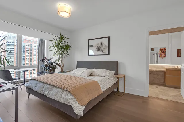 a living room with furniture and floor to ceiling windows