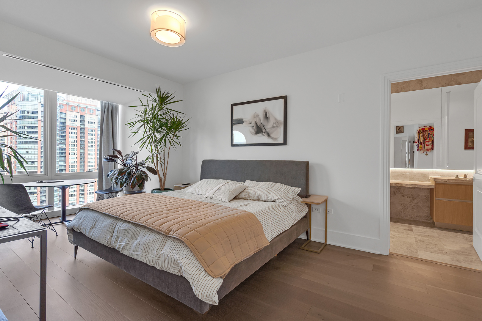 363 East Wacker Drive, Unit 1402 Chicago, IL 60601 - Photo 30 of 75 a bedroom with a large bed and a potted plant
