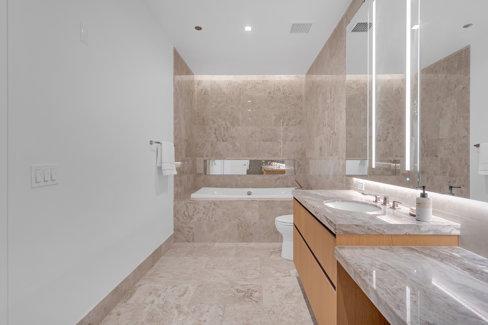 363 East Wacker Drive, Unit 1402 Chicago, IL 60601 - Photo 32 of 75 a bathroom with a granite countertop sink and a mirror