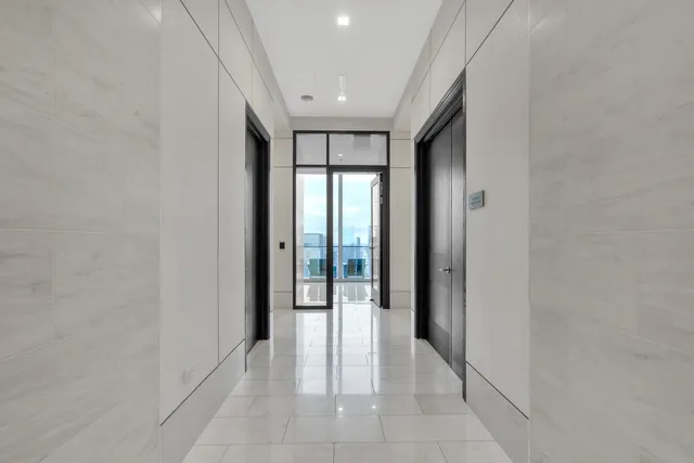 a living room with fireplace furniture and a large window