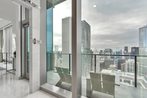 a living room with stainless steel appliances kitchen island granite countertop furniture and a flat screen tv