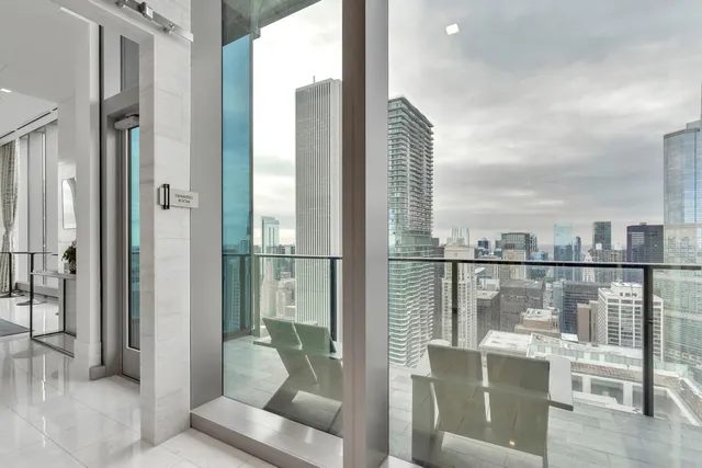 a living room with stainless steel appliances kitchen island granite countertop furniture and a flat screen tv