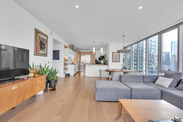 a kitchen with a dining table chairs and refrigerator