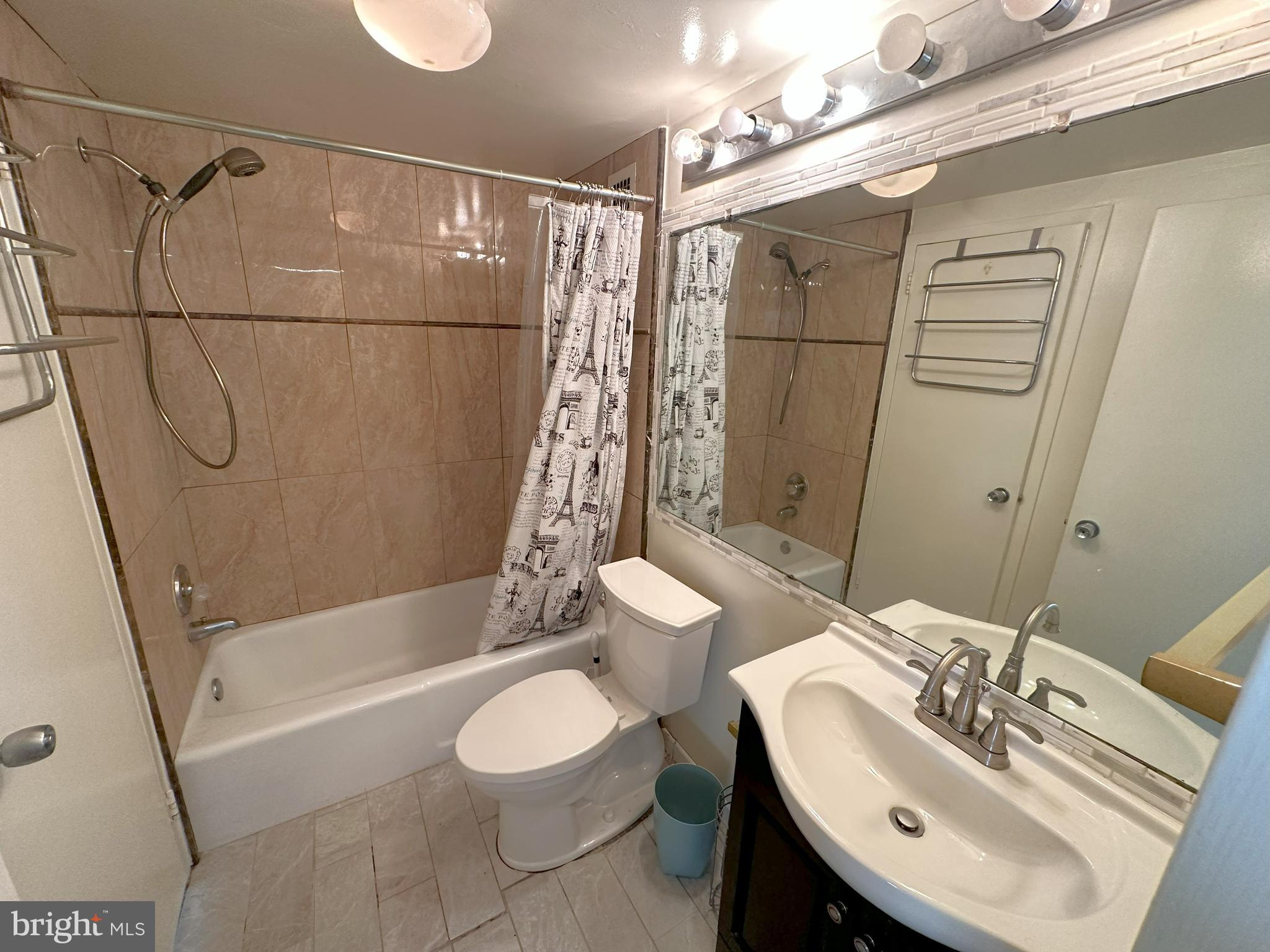 5500 Friendship Boulevard, Unit 1125N Chevy Chase, MD 20815 - Photo 13 of 48 a bathroom with a sink a toilet and shower