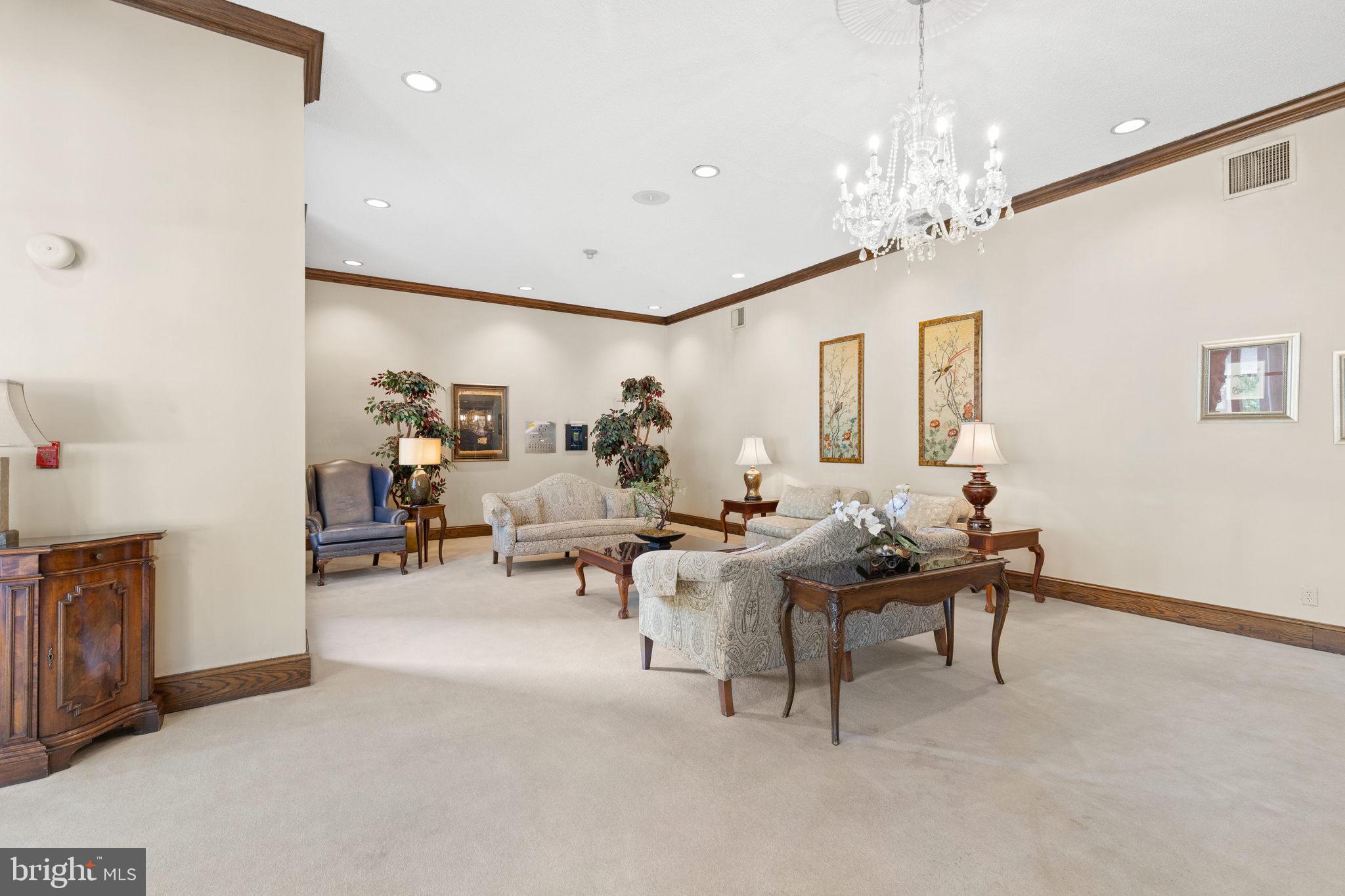 5500 Friendship Boulevard, Unit 1125N Chevy Chase, MD 20815 - Photo 22 of 48 a living room with furniture a chandelier and a dining table
