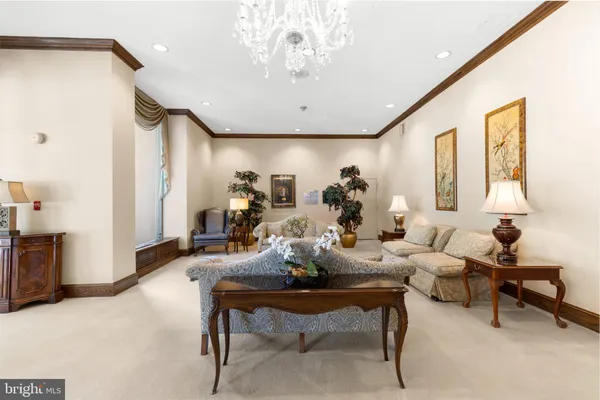 a living room with furniture and a chandelier