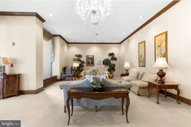 a living room with furniture and a chandelier