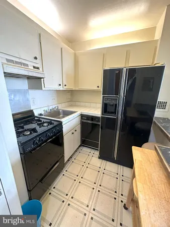 a kitchen with stainless steel appliances a stove a sink and a refrigerator