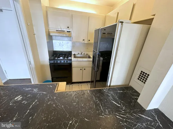 a kitchen with stainless steel appliances a refrigerator and a stove