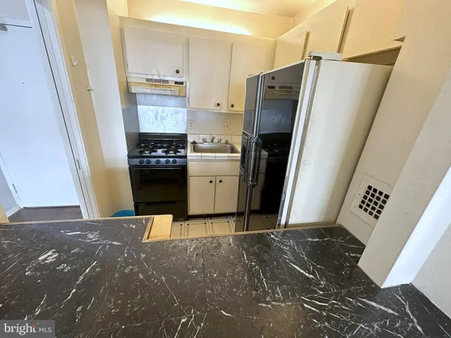 a kitchen with stainless steel appliances a refrigerator and a stove